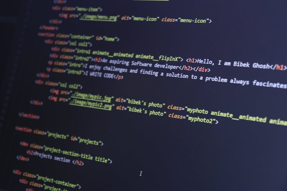 A close-up photograph of a computer screen displaying a code editor with an open HTML file named 'index.html'. The code includes elements such as the DOCTYPE declaration, html, head, and body tags, wi